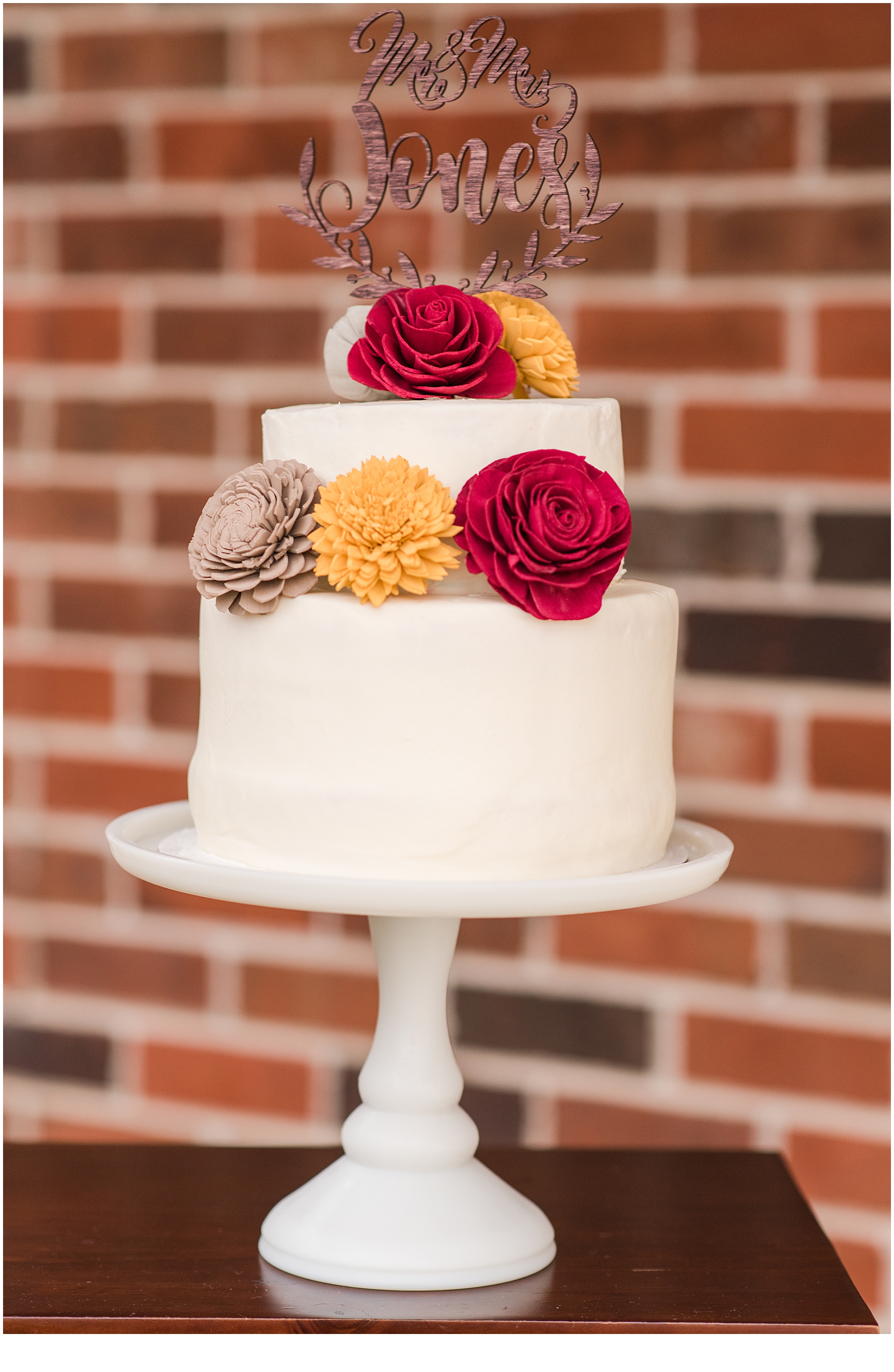Wooden wedding flowers on a two-tier wedding cake for a Tennessee Farm Elopement.