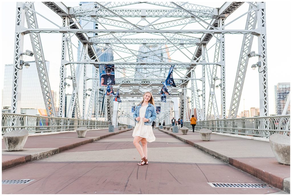 High school senior standing on the Nashville Pedestrian Bridge.
