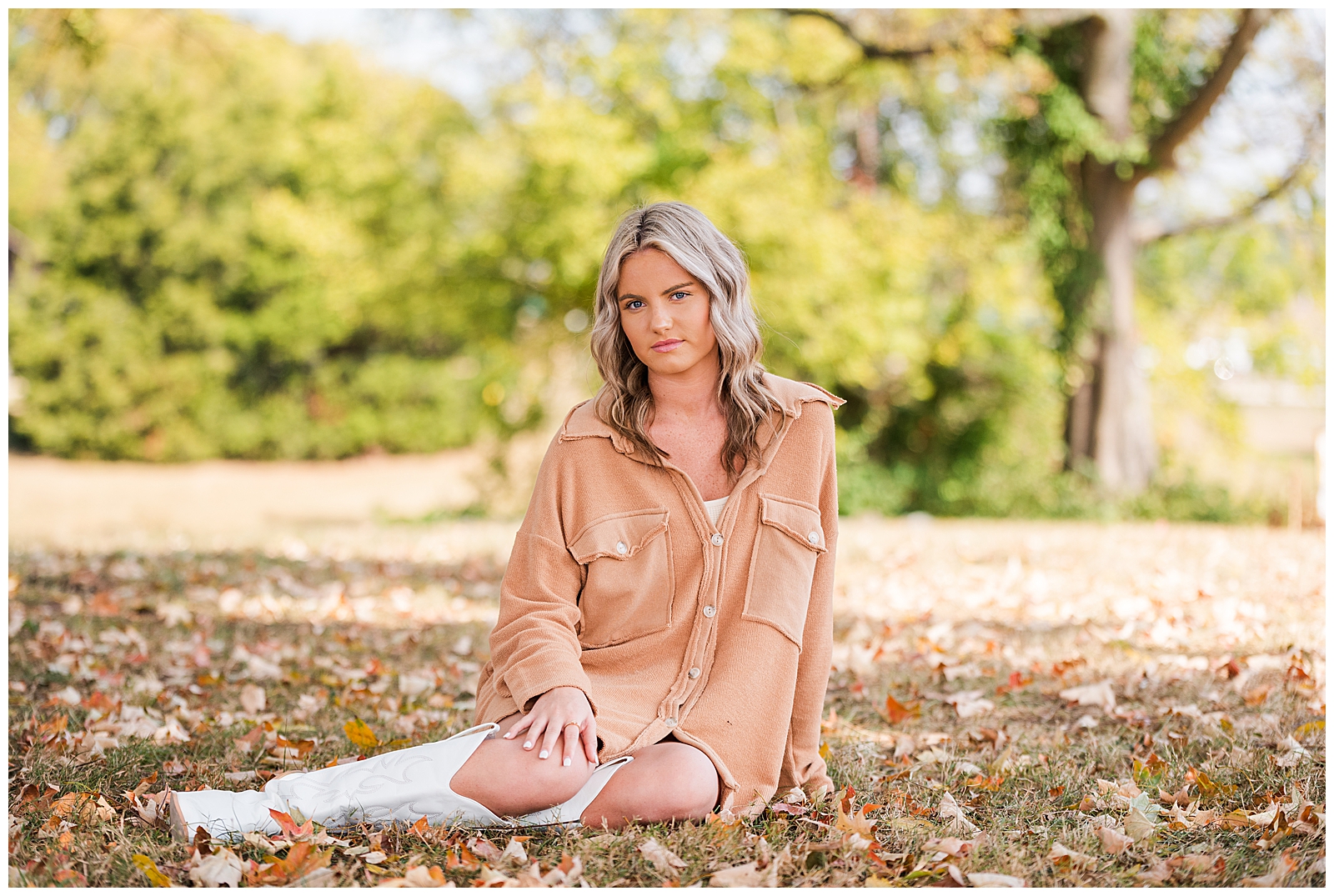 High school senior girl sitting in the leaves at The Park at Harlinsdale Farm, Franklin, TN. 