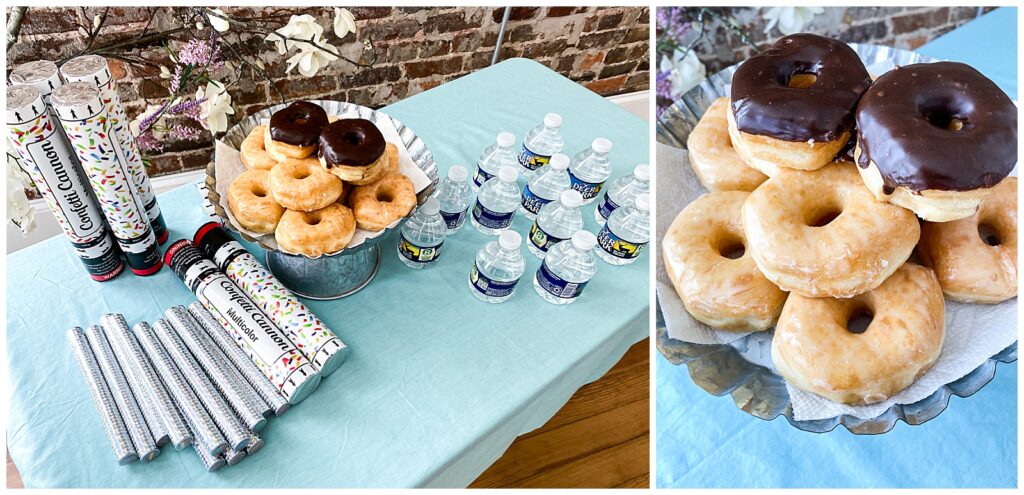 Doughnuts, bottles of water, and confetti cannons on a table.