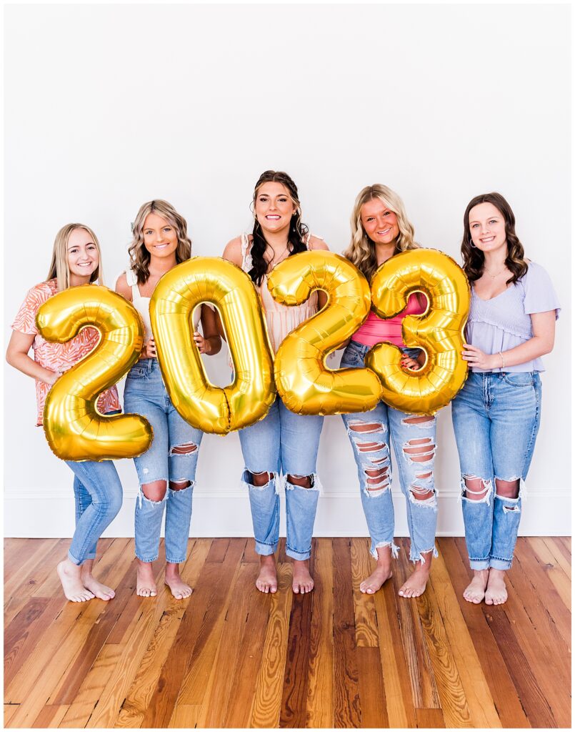 High school senior spokesmodels hold up gold 2023 numbers.