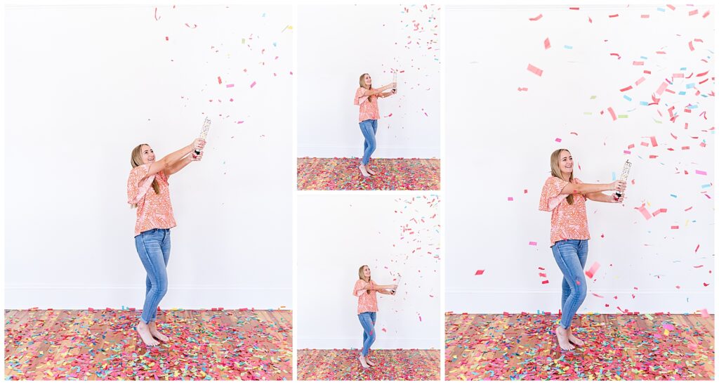A high school senior spokesmodel wearing jeans and an orange and white top laughs as she pops a confetti cannon for photos. 