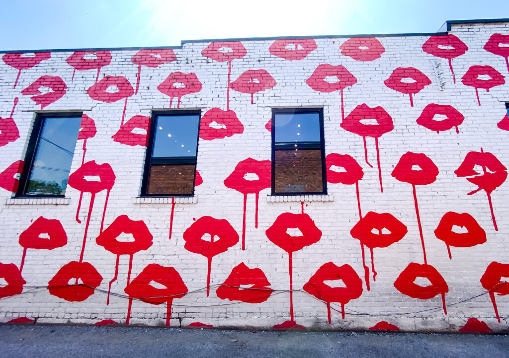 Red lips that lipstick is dripping off of them on a Nashville mural.