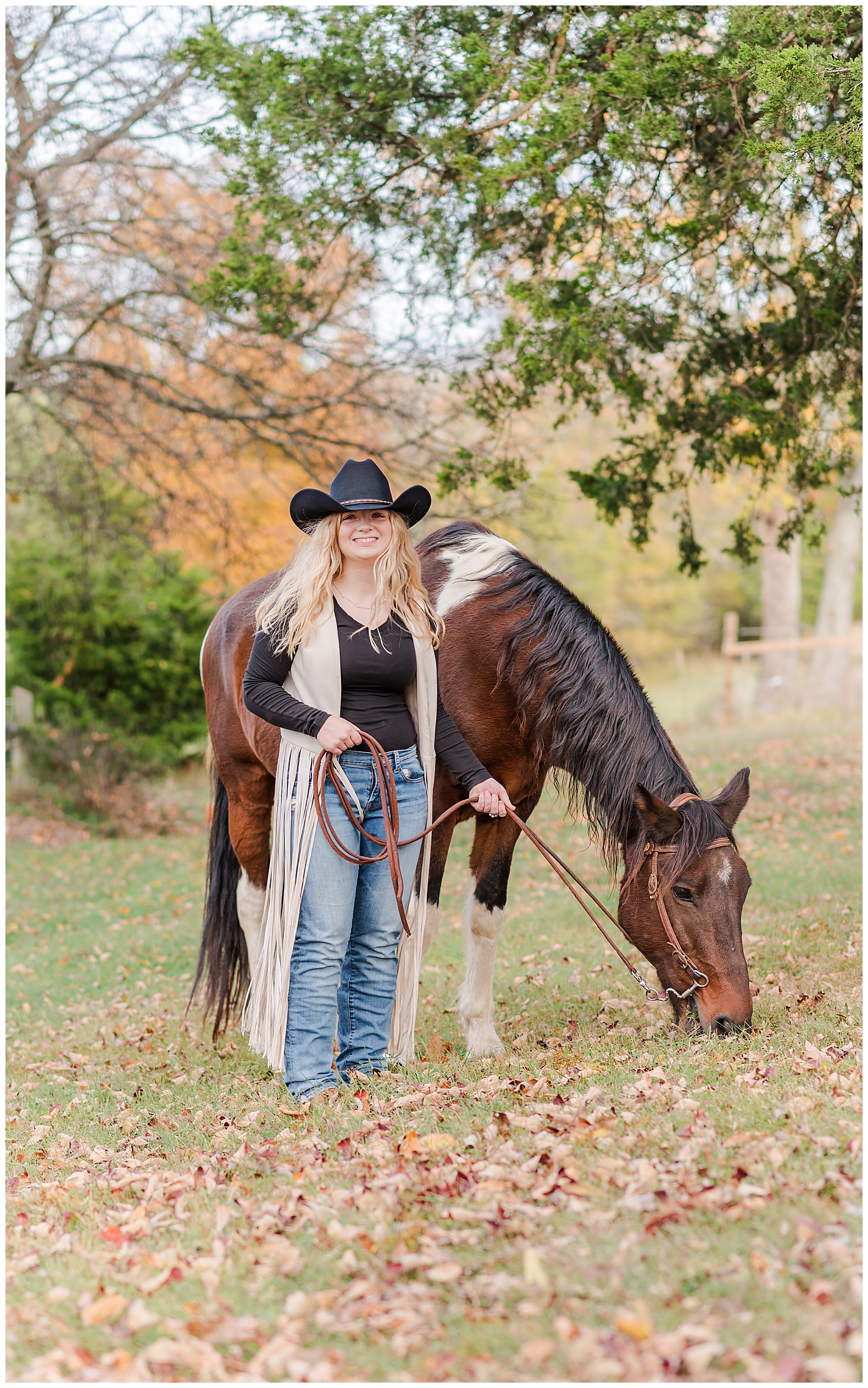 Nashville girl wearing a black cowgirl hat, standing next to a horse during her Equine Senior Session.