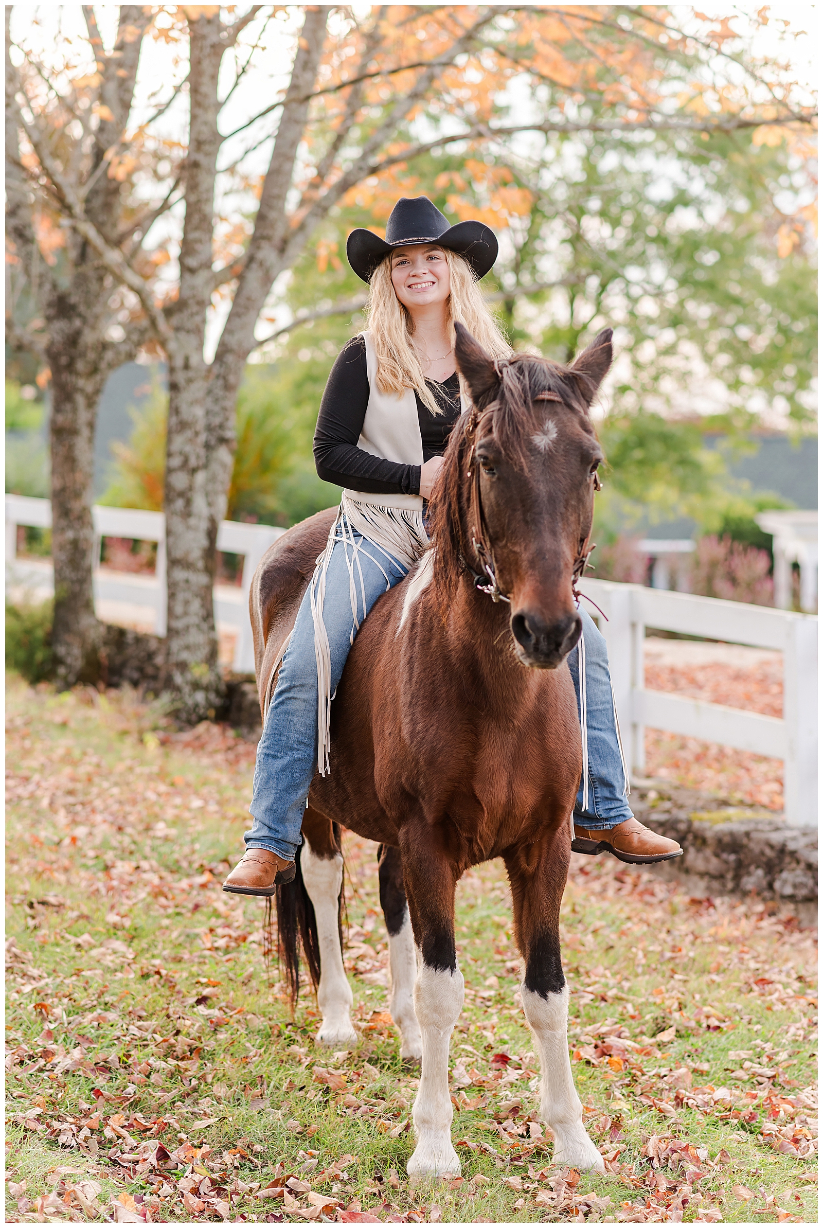Nashville girl wearing a black cowgirl hat, riding a horse during her Equine Senior Session.