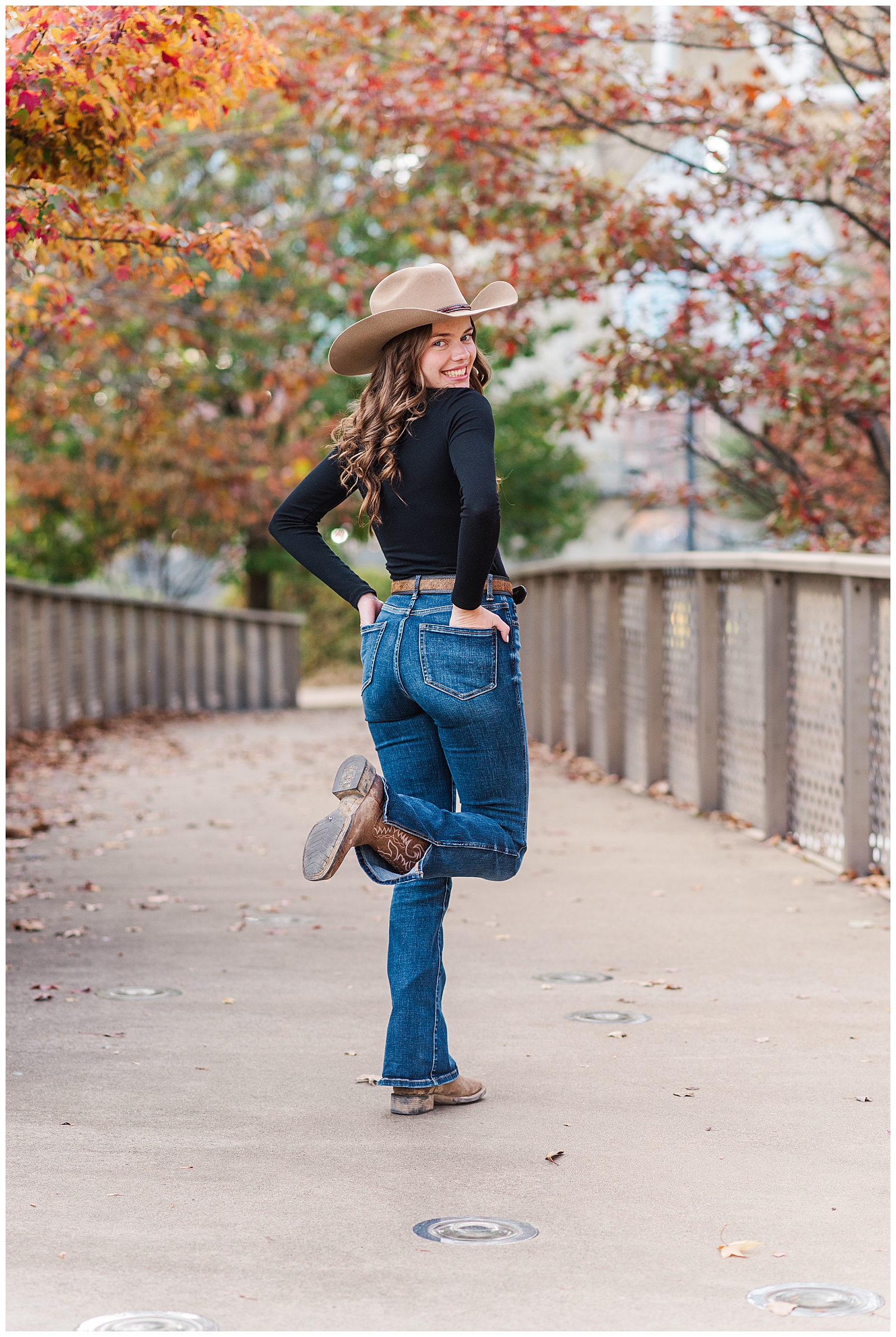 High school senior wearing jeans and a cowboy hat in Nashville, TN