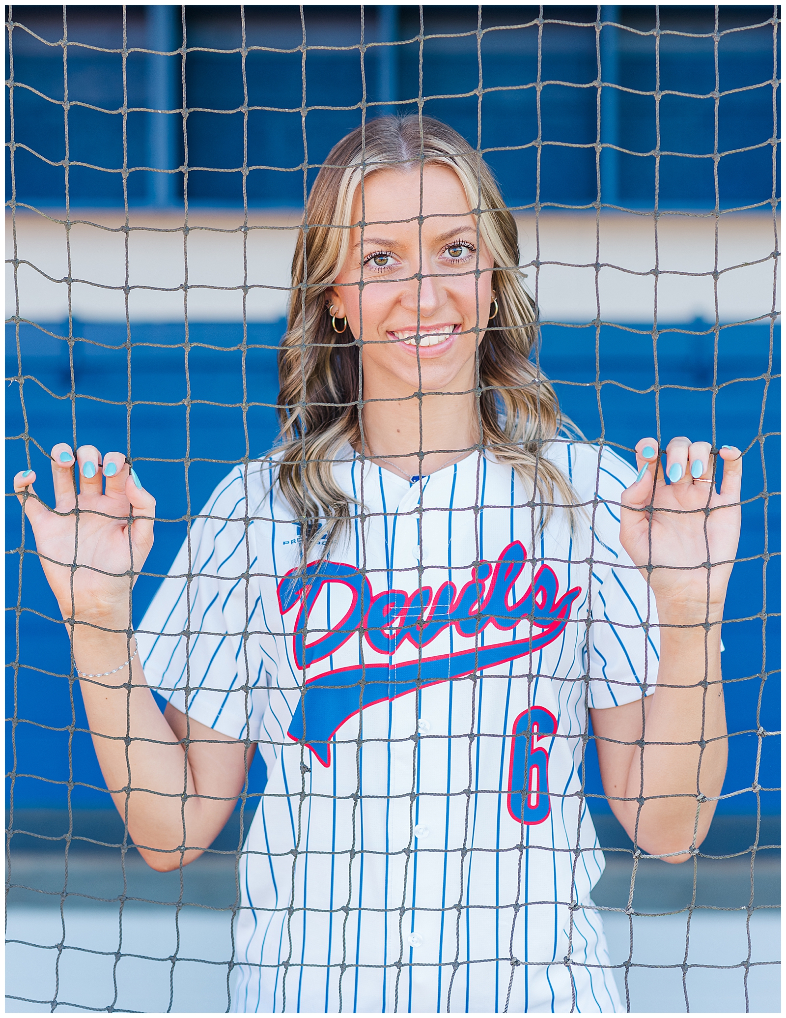 Senior girl in the dugout of her high school softball team.